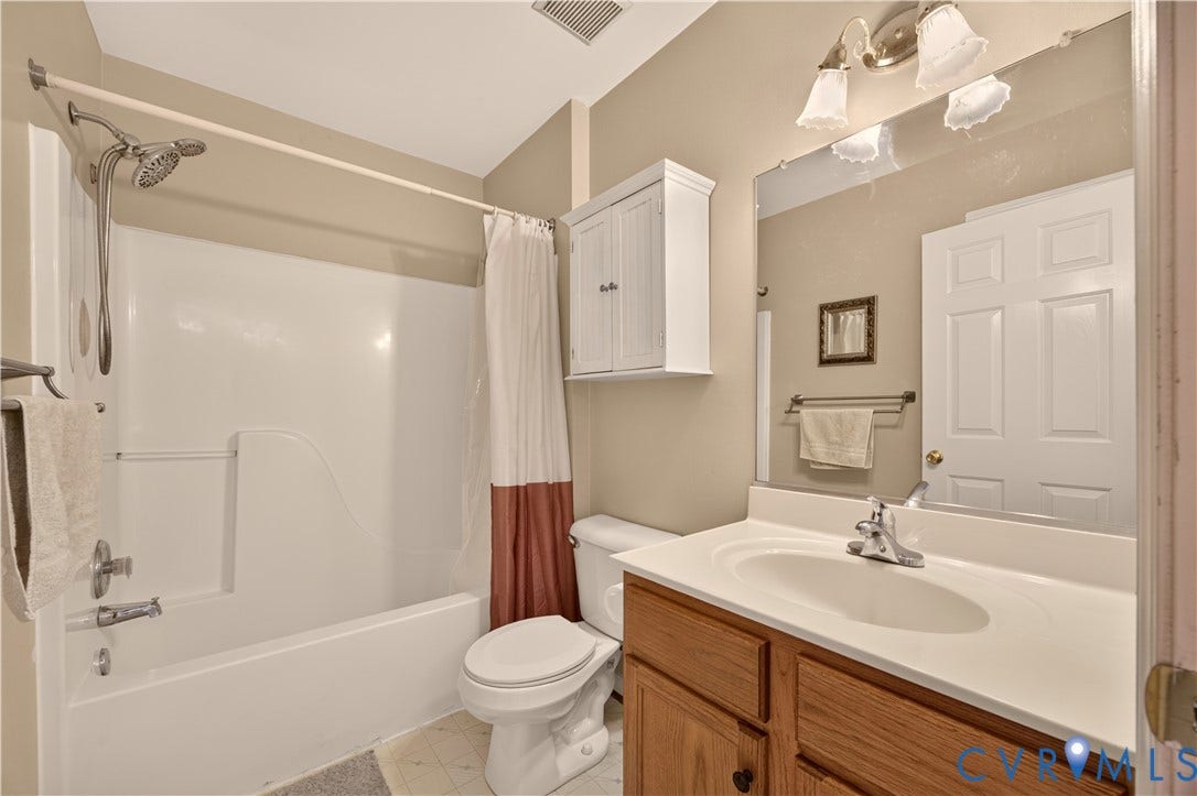 9516 Hungary Woods Drive, Henrico, VA 23060 Bathroom featuring a vanity with wood-finish cabinetry, a white countertop with integrated sink, and a built-in cabinet