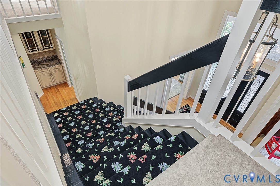 Split staircase leads to kitchen/family room
