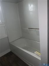 3119-B 4th Avenue, Richmond, VA 23222 White bathtub with an integrated shower surround and dark wood-finish flooring