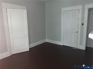 3119-B 4th Avenue, Richmond, VA 23222 Dark wood-finish flooring with light gray walls, featuring white trim and white panel doors