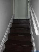 3119-B 4th Avenue, Richmond, VA 23222 Wood-finish stairs with white risers and a wall-mounted handrail