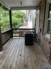 3119-B 4th Avenue, Richmond, VA 23222 Covered porch with wood plank flooring and wood railing