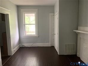 3119-B 4th Avenue, Richmond, VA 23222 Wood-finish flooring with white trim, a window with white casing, and a white mantel