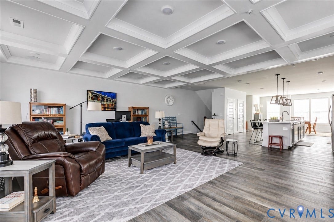 2 Flatwater Row, #B, Rocketts Landing, Henrico, VA 23231 Coffered ceilings with recessed lighting, wood-finish flooring, kitchen island with built-in sink and pendant lighting, and white paneled doors