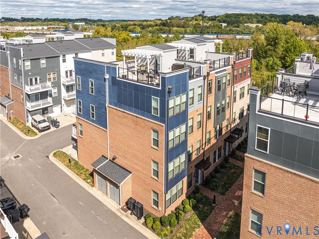 2 Flatwater Row, #B, Rocketts Landing, Henrico, VA 23231 Multi-level townhome featuring a brick and siding exterior, multiple windows, and a rooftop deck with a pergola