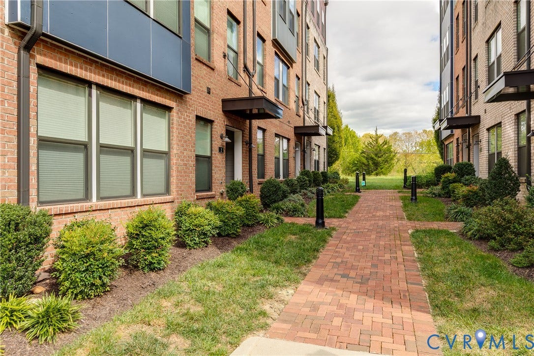 2 Flatwater Row, #B, Rocketts Landing, Henrico, VA 23231 Brick exterior with dark trim windows, contemporary multi-story facade, and a brick paver walkway