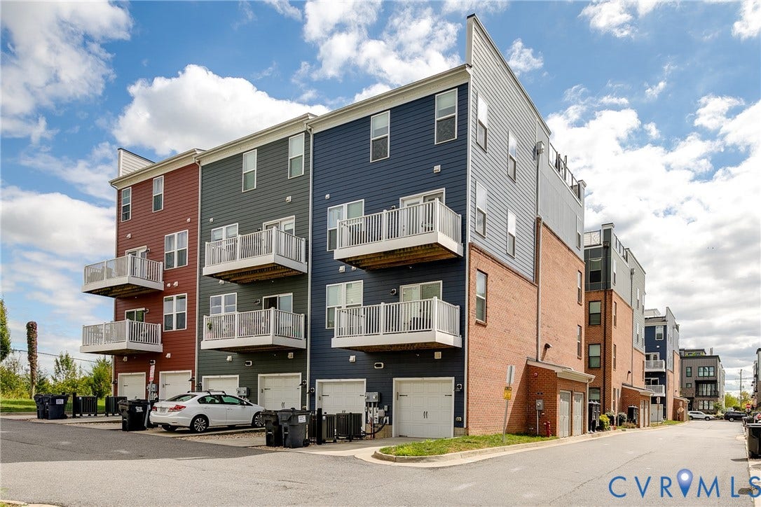 2 Flatwater Row, #B, Rocketts Landing, Henrico, VA 23231 Multi-story residence featuring distinct siding colors, individual garage access, and private balconies with white railings
