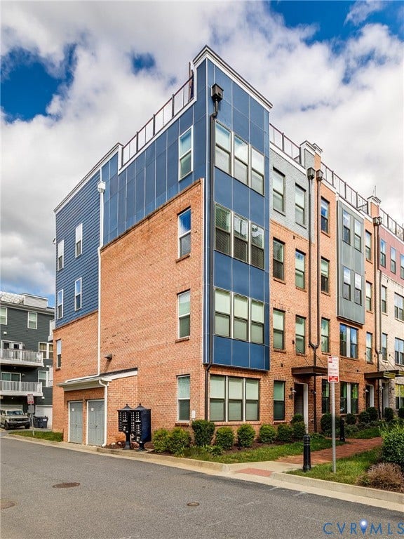 2 Flatwater Row, #B, Rocketts Landing, Henrico, VA 23231 Multi-level townhome featuring brick and panel siding, multiple windows, and a flat roofline