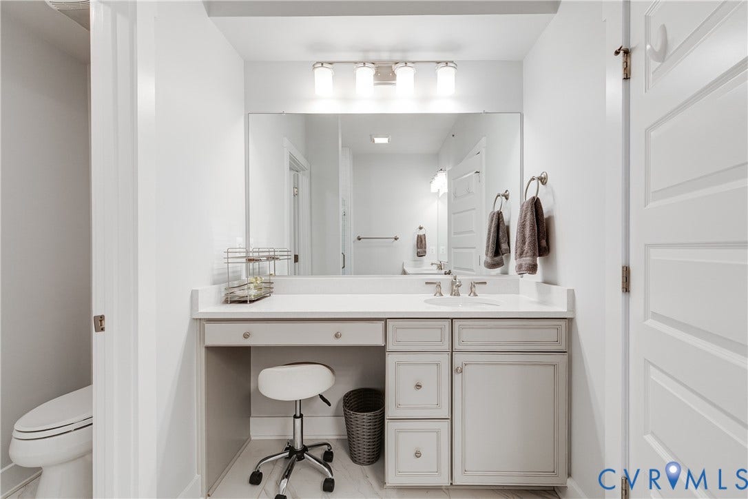 2 Flatwater Row, #B, Rocketts Landing, Henrico, VA 23231 Vanity with an integrated sink, polished chrome faucet, stone-finish countertop, and built-in cabinetry