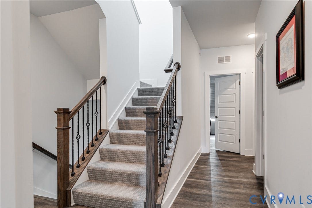 2 Flatwater Row, #B, Rocketts Landing, Henrico, VA 23231 Staircase featuring wood newel posts, wood handrails, and decorative black iron balusters