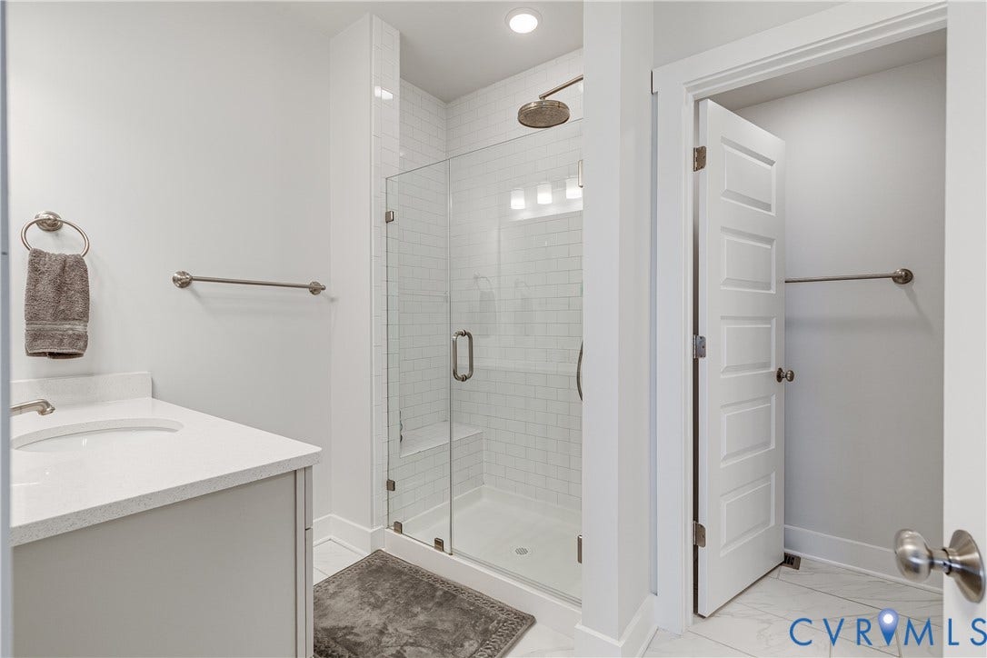 2 Flatwater Row, #B, Rocketts Landing, Henrico, VA 23231 Glass-enclosed shower with subway tile surround, rain shower head, built-in shower bench, and recessed lighting
