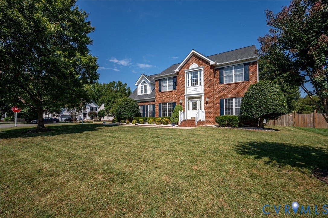 10808 Pruett Lane, Henrico, VA 23059 Brick colonial-style residence featuring a prominent front entrance, white columns, and black shutters