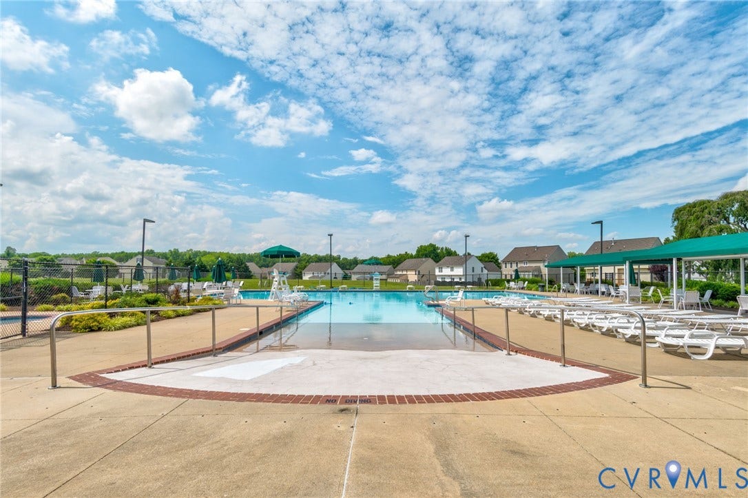 10808 Pruett Lane, Henrico, VA 23059 Community swimming pool featuring a concrete deck and surrounding lounge area with a green awning