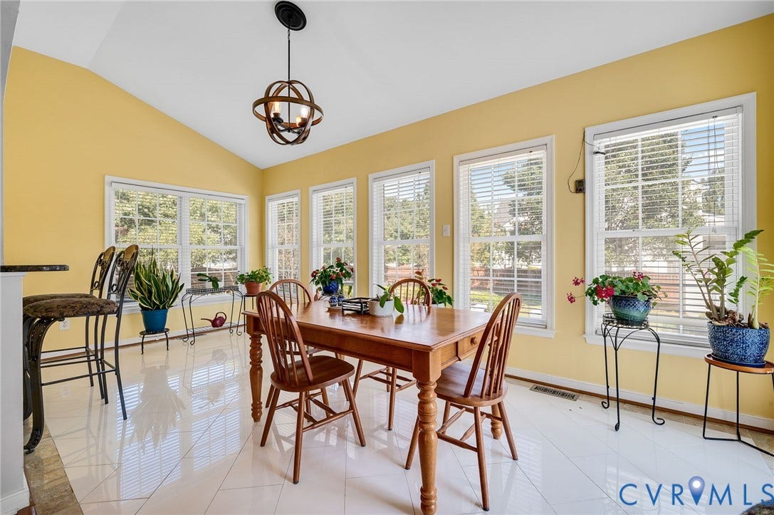 10808 Pruett Lane, Henrico, VA 23059 Vaulted ceiling with an orb pendant light fixture, multiple windows, and light-toned tile flooring