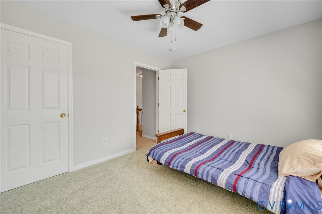 10808 Pruett Lane, Henrico, VA 23059 Pale green carpeting with white baseboards and a ceiling fan with light fixture