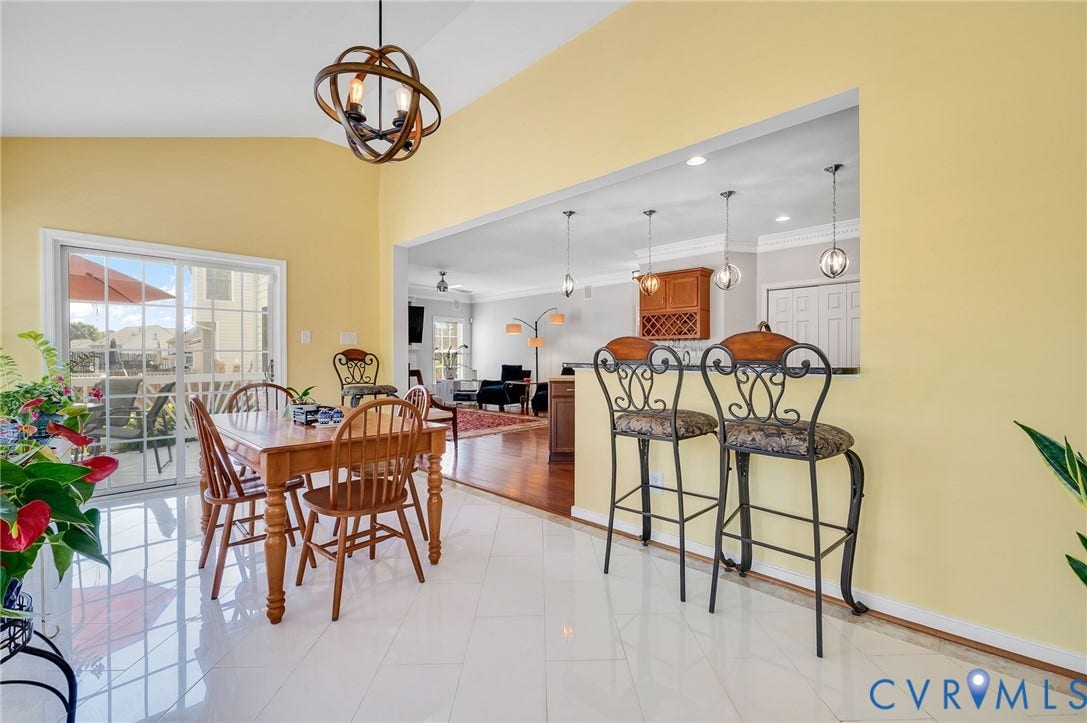 10808 Pruett Lane, Henrico, VA 23059 Vaulted ceiling with an orb chandelier, white tile flooring, and a sliding glass door