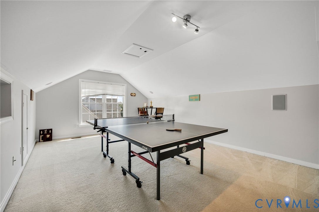10808 Pruett Lane, Henrico, VA 23059 Carpeted room featuring a window with blinds, sloped ceilings, track lighting, and built-in wall speakers