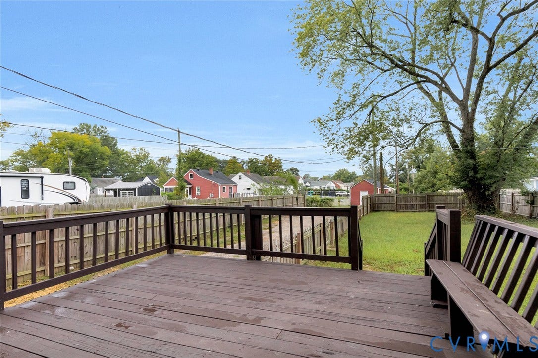 3504 Meadowbridge Road, Richmond, VA 23222 Spacious outdoor deck with built-in bench, wood railing, and backyard access