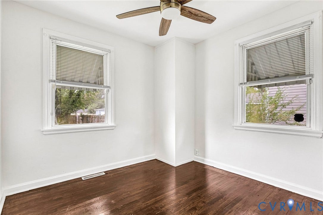 3504 Meadowbridge Road, Richmond, VA 23222 Hardwood flooring, white walls, two windows, and a Bedroom 2 2st floor. Ceiling fan with integrated lighting