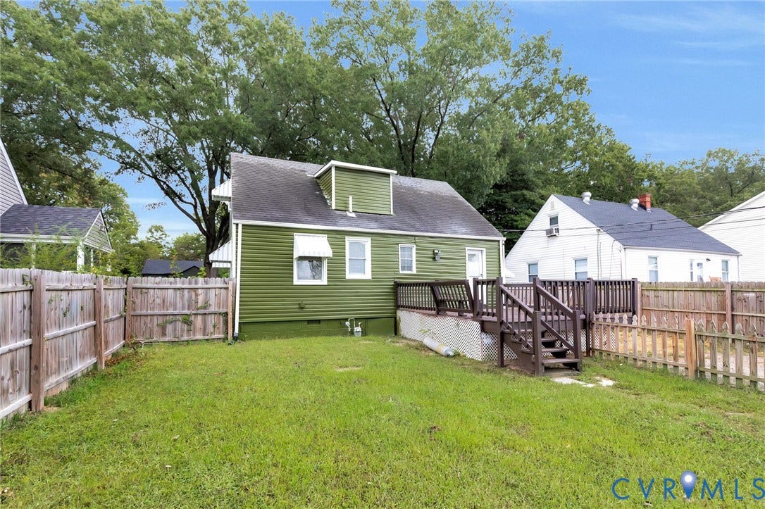 3504 Meadowbridge Road, Richmond, VA 23222 Expansive green space featuring a wooden privacy fence, a multi-level wooden deck, and green siding