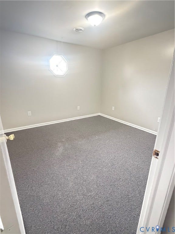 510 S Sycamore Street, Petersburg, VA 23803 Neutral wall paint, octagonal window, flush mount ceiling light, light-colored trim, and gray carpet