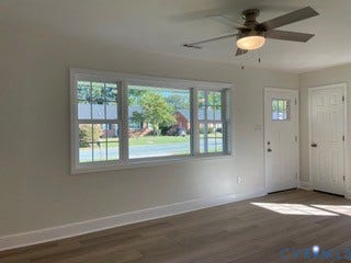 2315 Dee Kay Drive, Henrico, VA 23228 Light-toned wood-finish flooring, white walls, multi-pane window, ceiling fan with integrated lighting, and a white entry door with a multi-pane glass insert