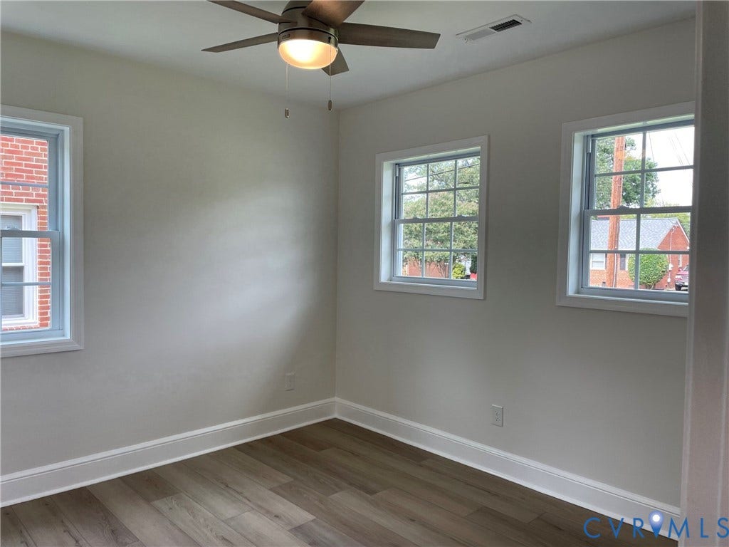 2315 Dee Kay Drive, Henrico, VA 23228 Contemporary ceiling fan with integrated lighting, multiple windows, light-toned wall finishes, and wood-finish flooring