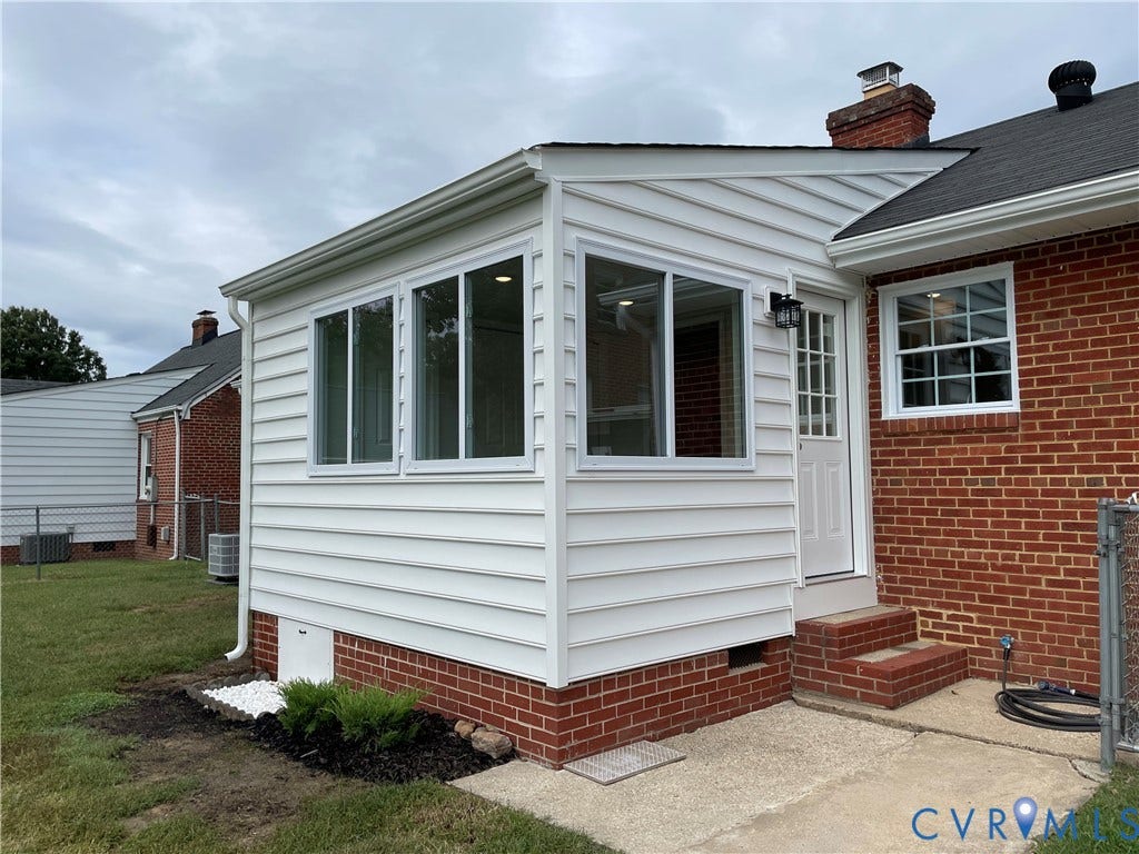 2315 Dee Kay Drive, Henrico, VA 23228 Sunroom addition featuring white siding and multiple windows