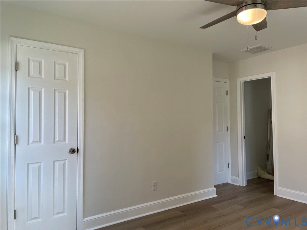 2315 Dee Kay Drive, Henrico, VA 23228 Wood-finish flooring, neutral wall tones, multi-panel doors with brushed nickel hardware, and a ceiling fan with integrated lighting