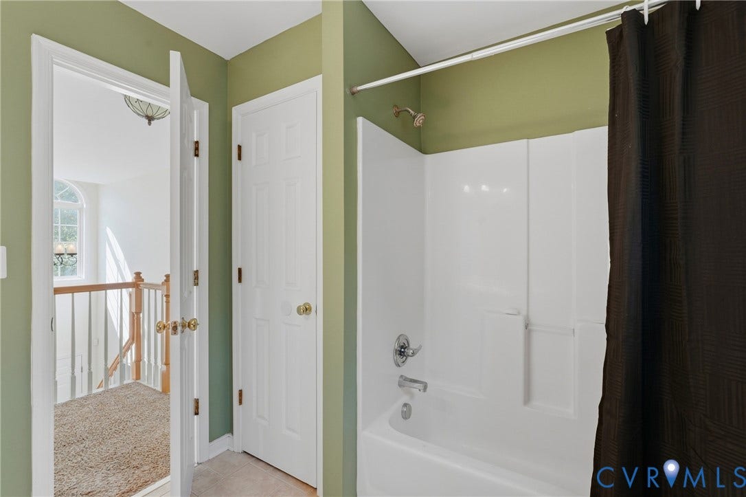 White tub/shower combination with chrome fixtures