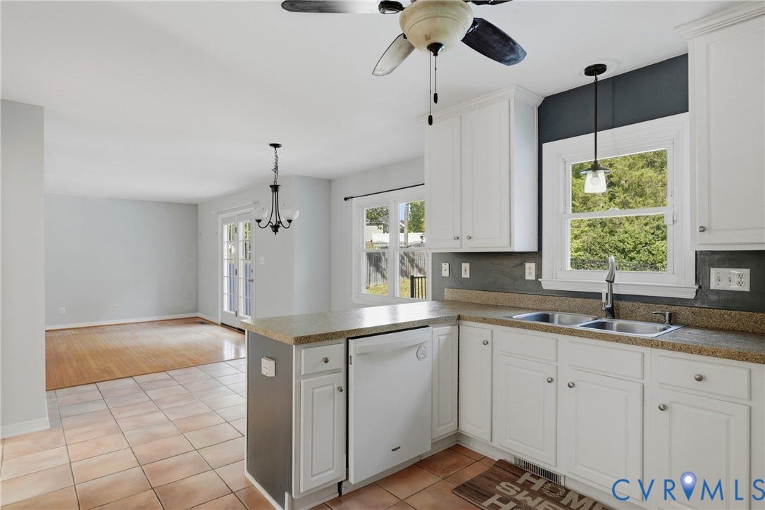 Kitchen featuring white cabinetry, a double basin stainless steel sink, a dishwasher, and a ceiling fan