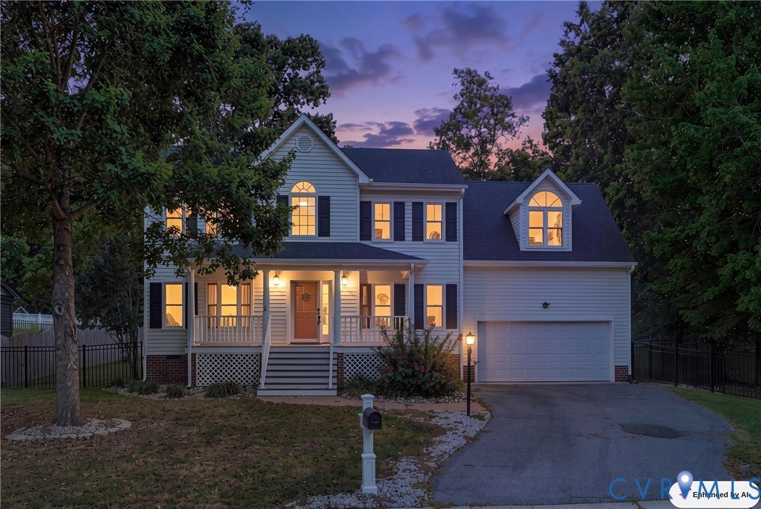Two-story property featuring white siding and black shutters