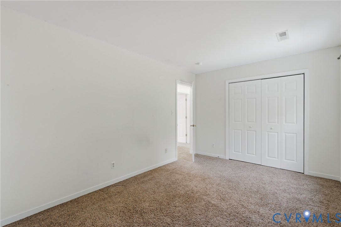 Neutral wall paint, carpet flooring, bi-fold closet doors, and recessed lighting