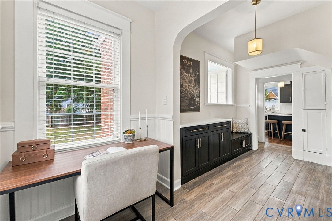 4905 Patterson Avenue, Richmond, VA 23226 Wood-finish flooring, built-in cabinetry with bench seating, recessed lighting, arched doorway, and a large window with white blinds