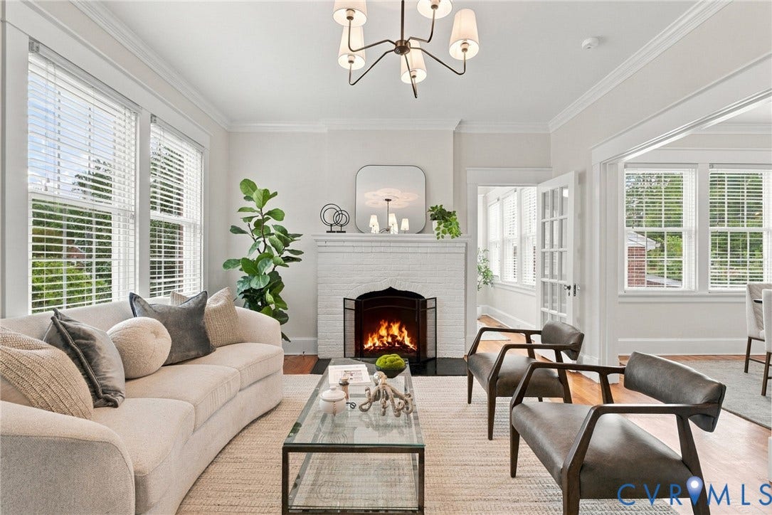 4905 Patterson Avenue, Richmond, VA 23226 Wood-finish flooring, white brick fireplace, elegant chandelier, crown molding, and French doors
