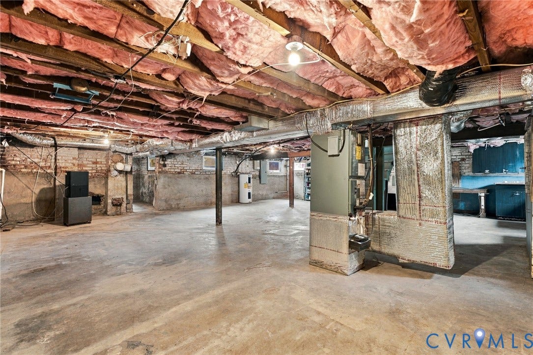 4905 Patterson Avenue, Richmond, VA 23226 Open basement space featuring exposed wood joists with insulation, concrete flooring, and brick foundation walls