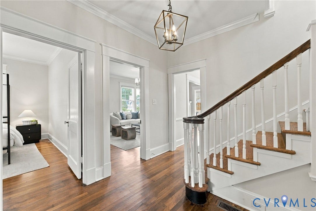4905 Patterson Avenue, Richmond, VA 23226 Hardwood flooring, painted white walls, crown molding, a built-in staircase with wood treads and a dark wood handrail, and a metal-frame ceiling light fixture
