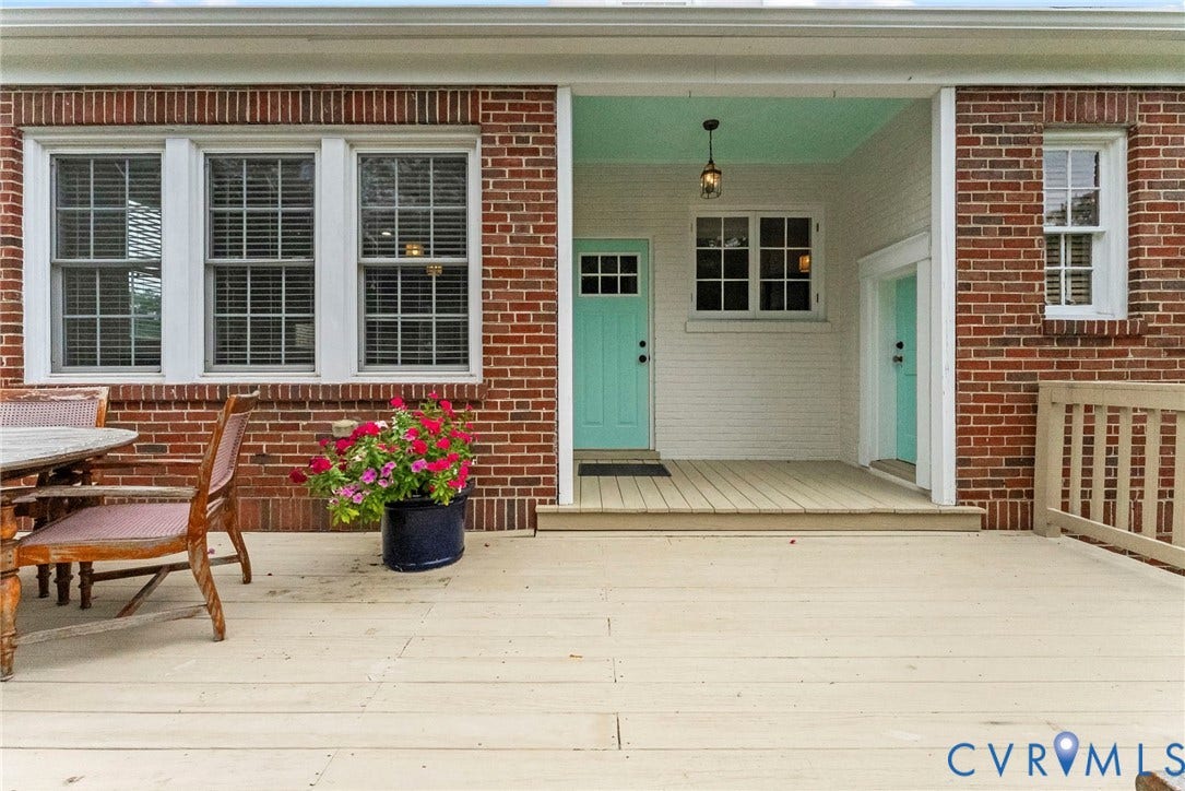 4905 Patterson Avenue, Richmond, VA 23226 Expansive wood deck with brick exterior, featuring a covered porch entry, transom window, and a light fixture
