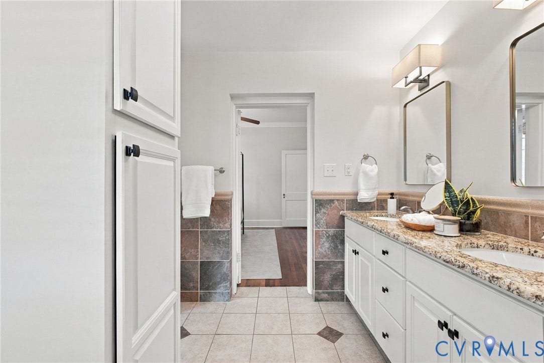 4905 Patterson Avenue, Richmond, VA 23226 Dual vanity with integrated sinks, granite countertop, and framed mirrors