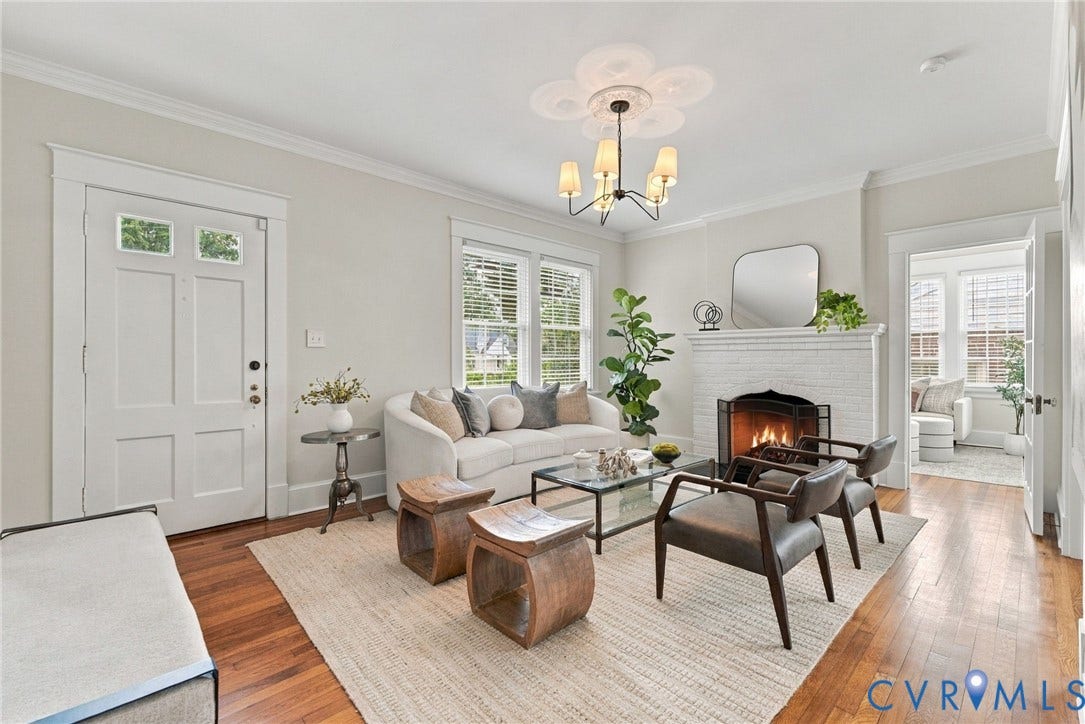 4905 Patterson Avenue, Richmond, VA 23226 Hardwood flooring with crown molding, brick fireplace with a mantel, and a decorative ceiling light fixture