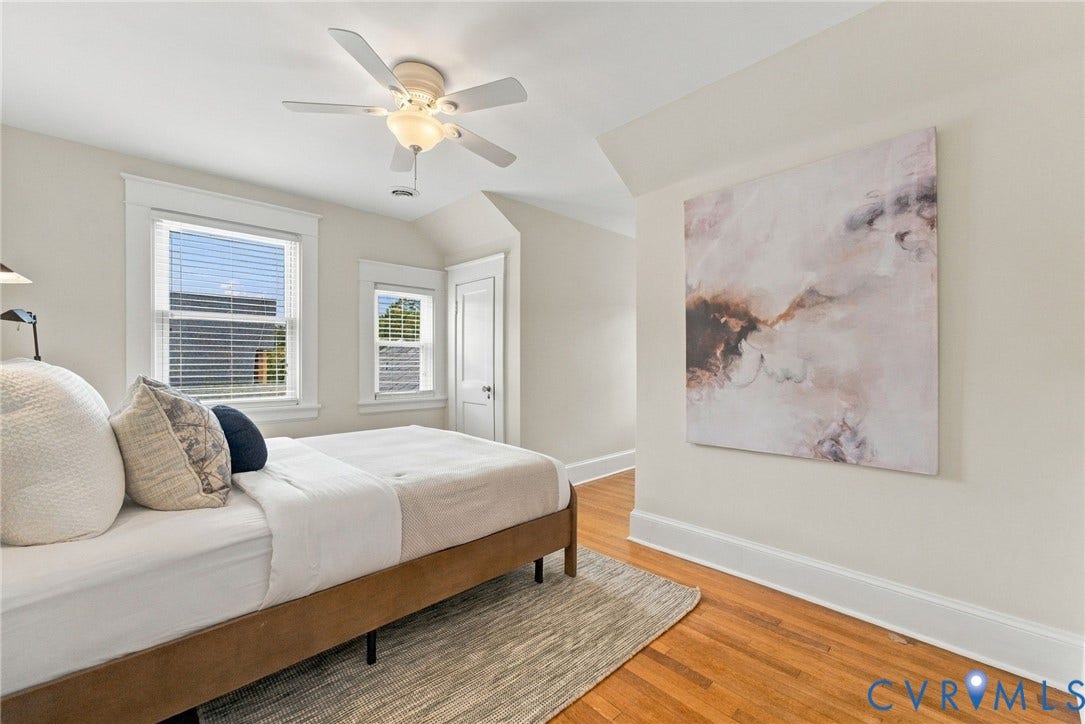 4905 Patterson Avenue, Richmond, VA 23226 Hardwood flooring, white trim details, multiple windows, ceiling fan with integrated lighting, and a paneled door