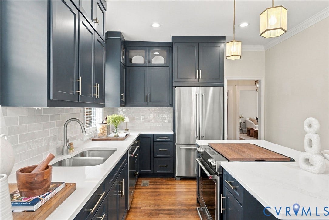 4905 Patterson Avenue, Richmond, VA 23226 Kitchen featuring deep blue cabinetry with brass hardware, stainless steel appliances, white countertops, and a subway tile backsplash