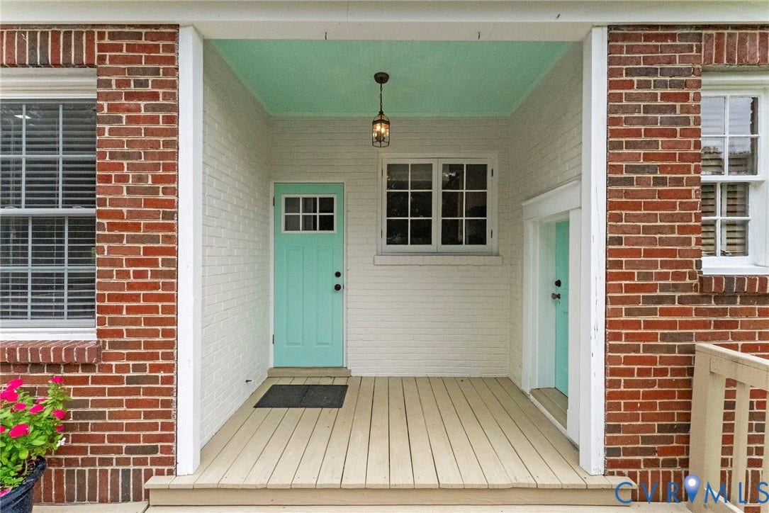 4905 Patterson Avenue, Richmond, VA 23226 Brick exterior with white painted brick accents, wood-finish porch flooring, and a light-colored entry door