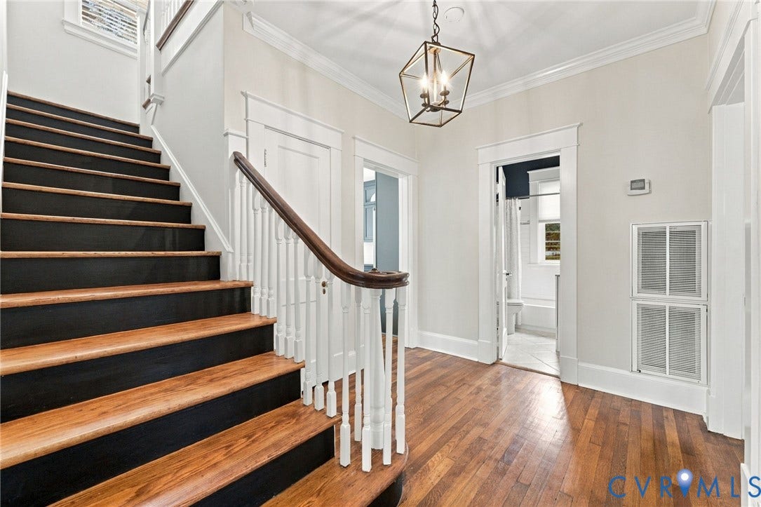 4905 Patterson Avenue, Richmond, VA 23226 Hardwood flooring, painted risers, wood handrail, white trim, and a decorative ceiling light fixture