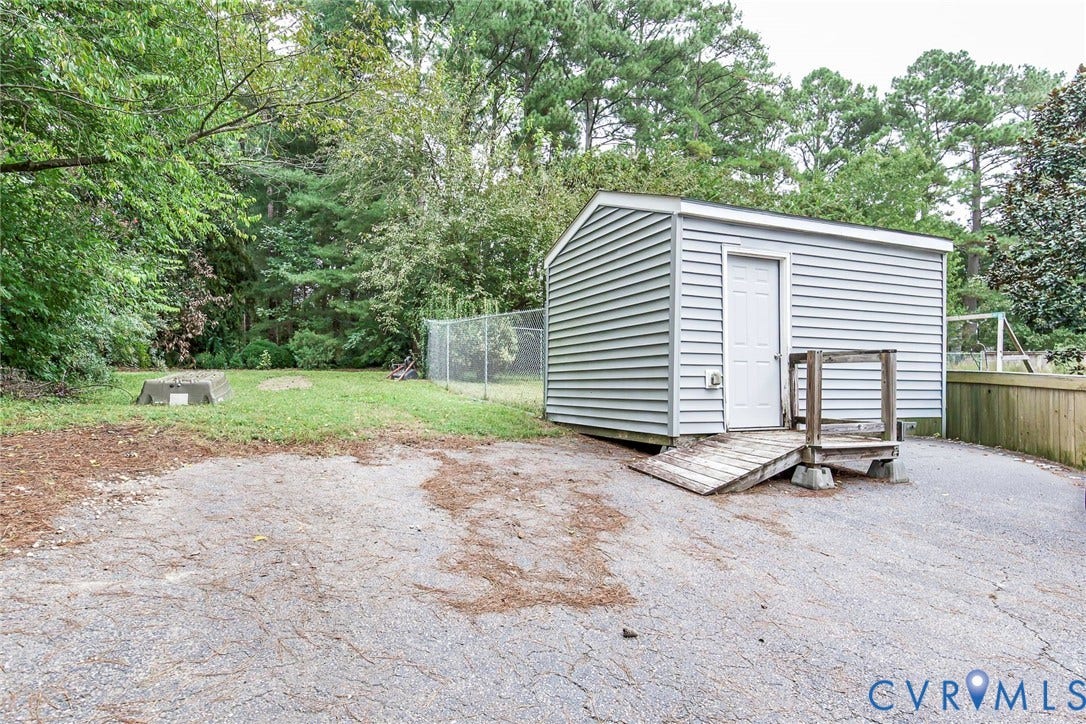 5640 Teterling Court, Lakewood Farms, Chester, VA 23831 Detached storage shed with siding exterior, wood ramp, and adjacent paved surface