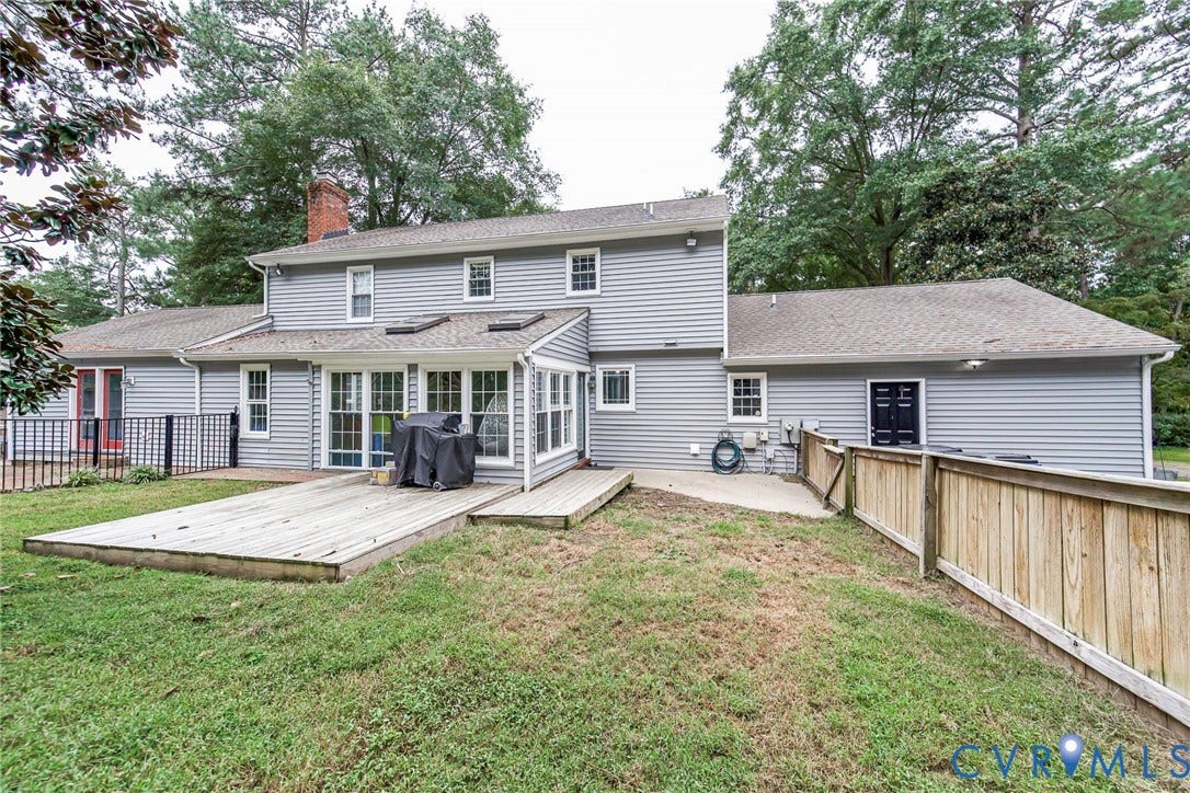 5640 Teterling Court, Lakewood Farms, Chester, VA 23831 Spacious rear exterior with gray siding, multiple windows, and a prominent brick chimney