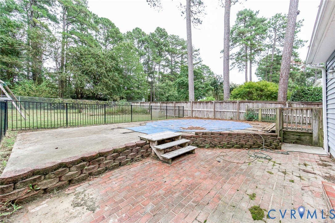 5640 Teterling Court, Lakewood Farms, Chester, VA 23831 Brick paver patio with a retaining wall, concrete patio, and fenced-in backyard
