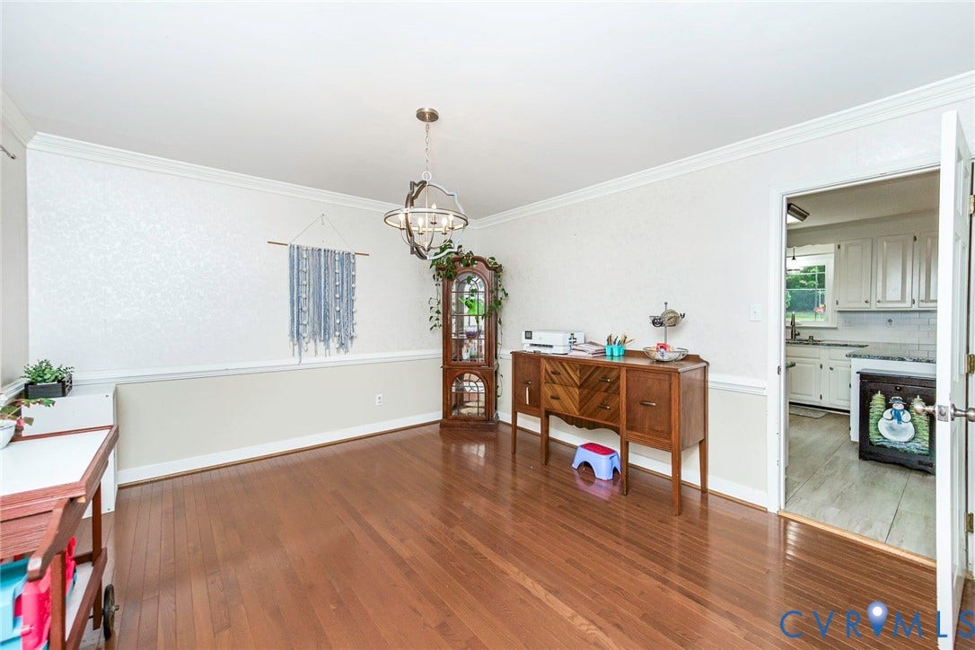 5640 Teterling Court, Lakewood Farms, Chester, VA 23831 Hardwood flooring, chair rail molding, crown molding, and a drum pendant light fixture