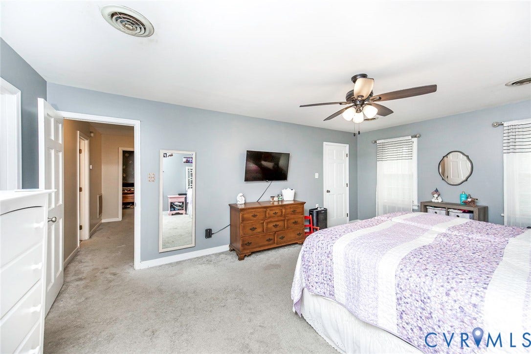 5640 Teterling Court, Lakewood Farms, Chester, VA 23831 Carpeted bedroom featuring a ceiling fan with integrated lighting, multiple windows with blinds, and white interior doors