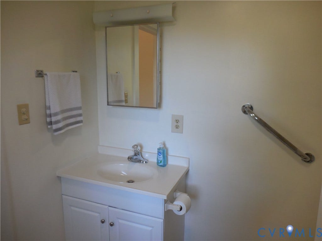 6507 Old Columbia Road, Columbia, Columbia, VA 23038 White vanity with integrated sink, chrome faucet, and mirrored medicine cabinet